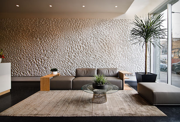The lobby with a textured wall backdrop. 