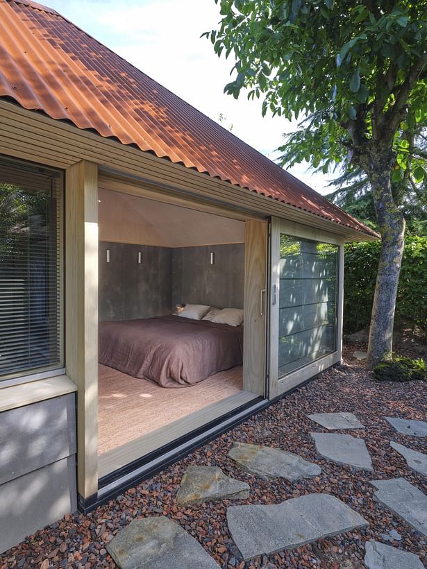 The Accoya wooden sliding door slides along the facade of the buiding