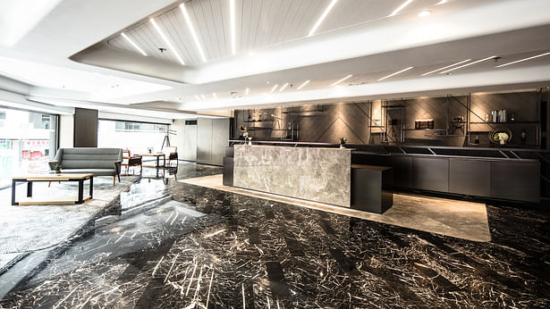 Lobby of Hotel Ease - black patterned marble arranged in handcrafted planks to create a dynamic look.