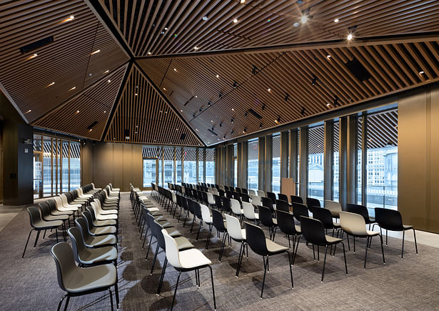 The new floor has pitched wood slat ceilings and contains a flexible 268-occupant conference and event center. Image copyright by John Bartelstone