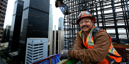 Working 300 feet above downtown Los Angeles, ironworkers position reinforcing steel onto the walls of the New Wilshire Grand. (via latimes.com; Photo: Mel Melcon)