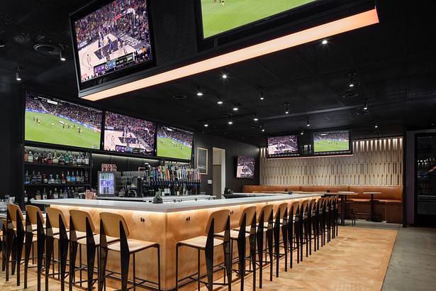 The Court-Side Bar is composed of wood which extends onto the floor. Made to feel like the Laker's basketball court.