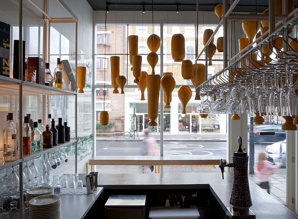 View to the street through restaurant bar with Binom designed ceramic lighting above