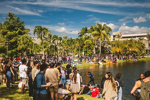 Students gather near 232-foot-wide lake behind the Steven and Dorothea Green Library at MMC for 'Walking on Water' competition. Image courtesy of FIU College of Communication, Architecture + the Arts.