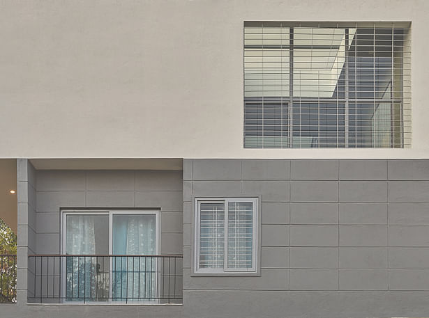 Versatile use of Lines - Lines manifest themselves throughout the elevation in different ways and on varied materials -the simple grooves on plaster, thin rods of the balcony railings, metal grills on the openings, adding subtle drama to the building skin.