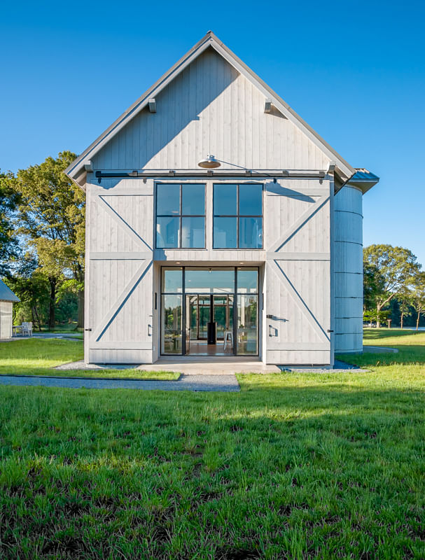 The position and design of this barn house minimizes impact to the critical-area terrain and protected waterway. 'Experience with critical area regulations is key when designing a waterfront house,' says Annapolis architect Devin Kimmel, AIA, ASLA.