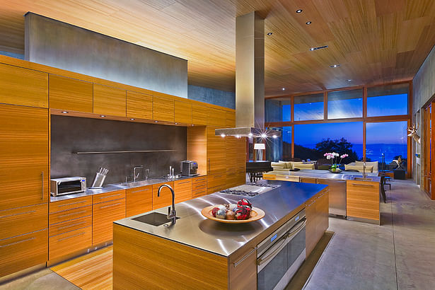 The secondary material of wood brings warmth through the ceiling and built-ins found in the kitchen.