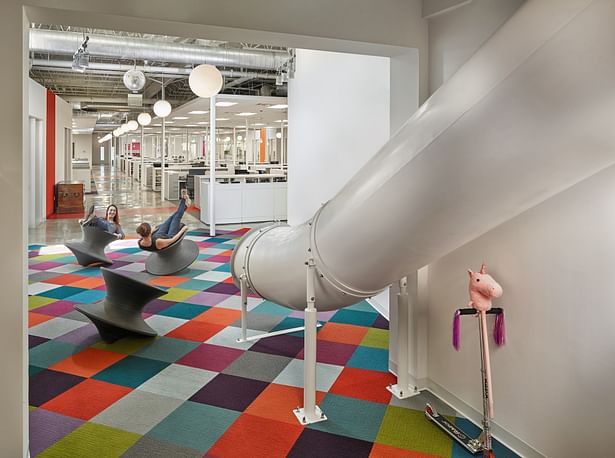Playful elements include slide and Herman Miller 'Spun' Chairs.