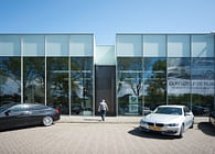 Bespoke TALL pivot/balance door. BMW Dealer, Eindhoven, The Netherlands