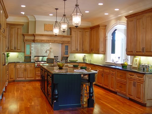 Custom hood surround and arched pass-thru window stand out in this kitchen.