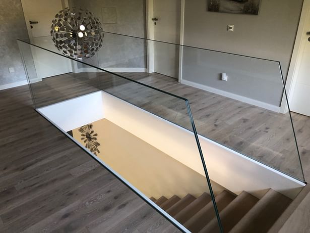 Floating Mistral design staircase supported by single sheet of low iron structural glass. 