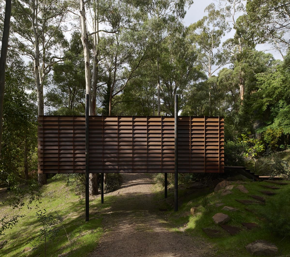 Robbie Walker's Sawmill Treehouse blends into the trees through its raised and compact form