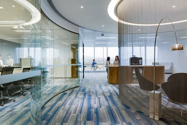 Accent chairs and carpets dotted around the space add in pops of colour - City Facilities Management in Hong Kong by Space Matrix