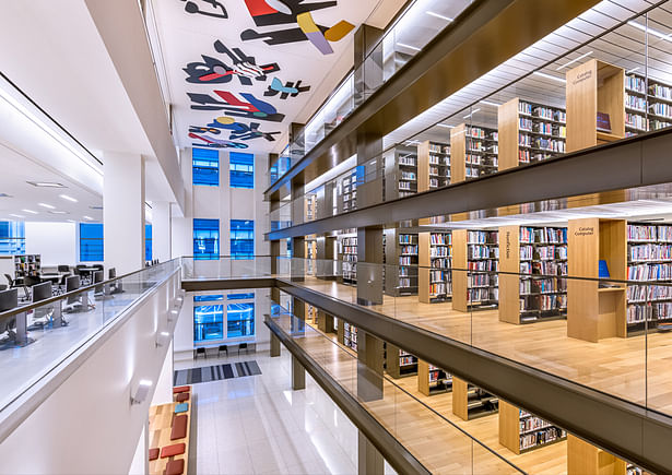 Through the library’s 40th Street windows, passers-by will see the northern end of the book stacks, visible as a continuous vertical wall of book spines welcoming New Yorkers into the space to browse. Image copyright by Max Touhey