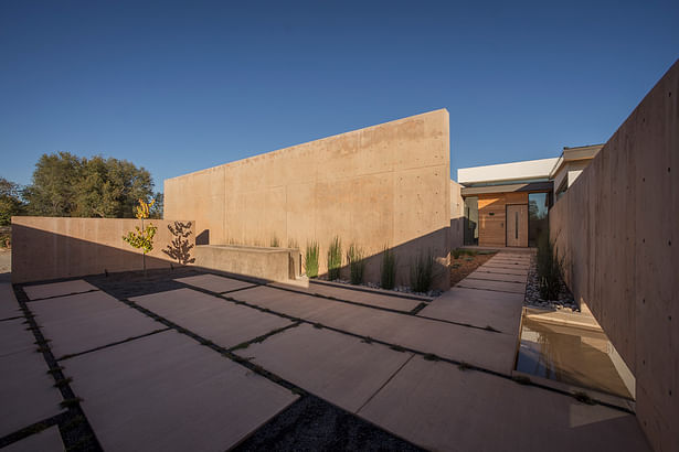 Panorama at entry courtyard, with parking to left and entry to right, water feature in foreground. Image: Robert Reck