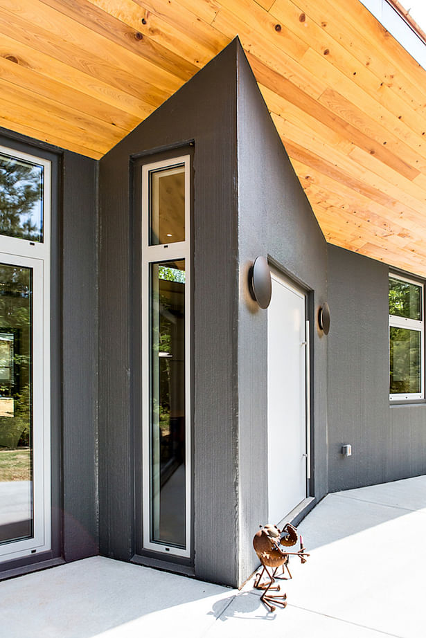 A slim side window lets natural light slip in behind the front door.