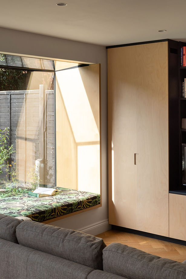 The oriel window seat is lined with Grade B/BB birch plywood, to match the adjacent joinery. Photograph by Adam Scott