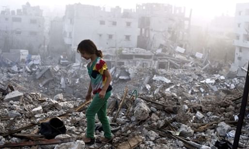 A Palestinian girl walks in Gaza’s Shejaiya neighbourhood, one of the hardest hit by recent fighting. (The Guardian; Photograph: Roberto Schmidt/AFP/Getty Images)