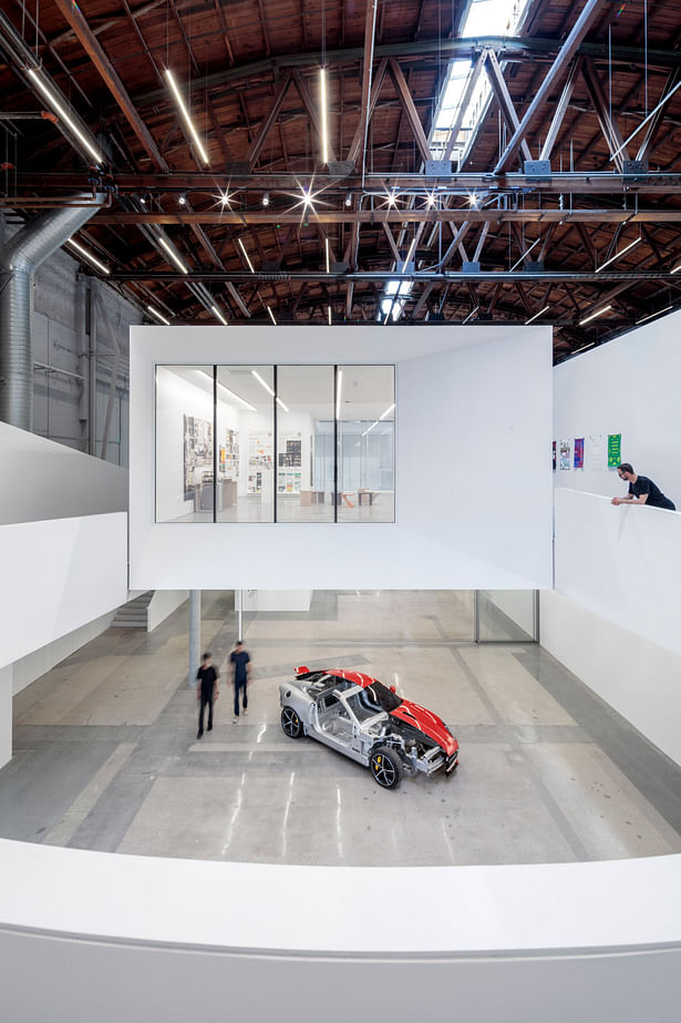 This image from the curved ramping gallery looks through the level two studio and down to the Art and Process Lab below featuring a “cut away” Jaguar F-Type. | Credit: Joshua White (jwpictures.com)