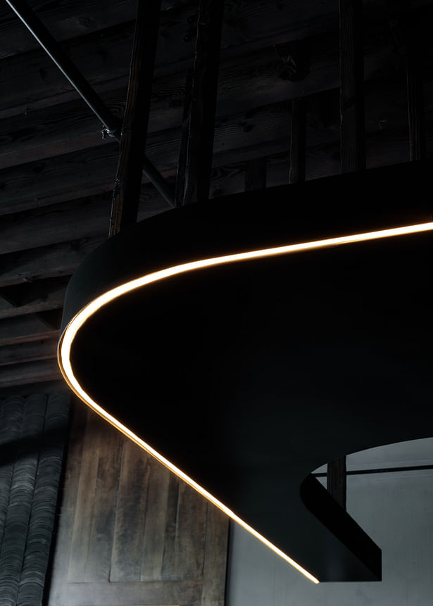 The Soffit, made of dark bronze metal, is suspended using reclaimed Hinoki (a Japanese Cypress) with its contemporary gentle curb and continuous LED strip, the Soffit juxtaposes the traditional materials.