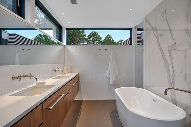 Primary bathroom is wrapped in high windows for privacy and lots of daylight. Credit: Brian Bailey