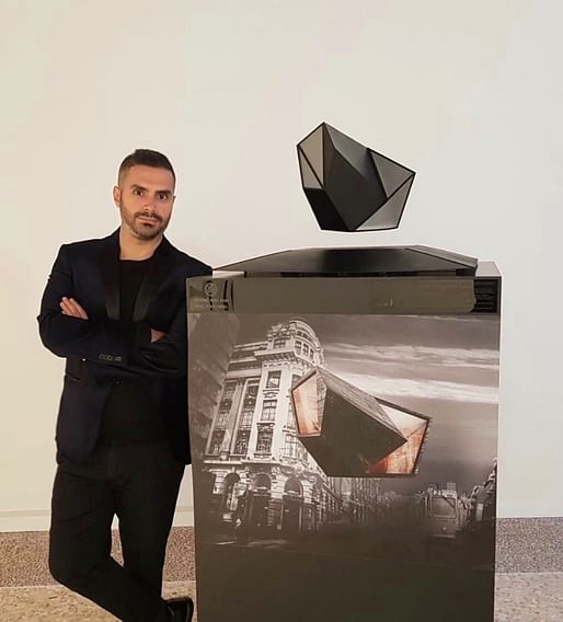 AUD chair of architecture Georges Kachaamy standing next to his floating model prototype 'Air Oases.' Image courtesy of Georges Kachaamy, via @AUDubai/Twitter