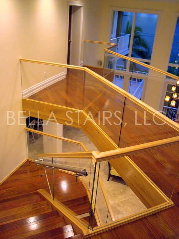 Glass railings were installed along the staircase and continued onto the second floor guardrail.