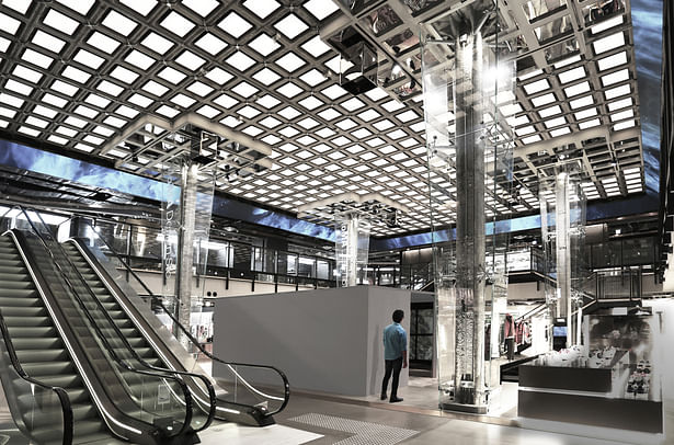 View of the atrium space, showing the waffle ceiling, and the glass- clad columns in the middle.