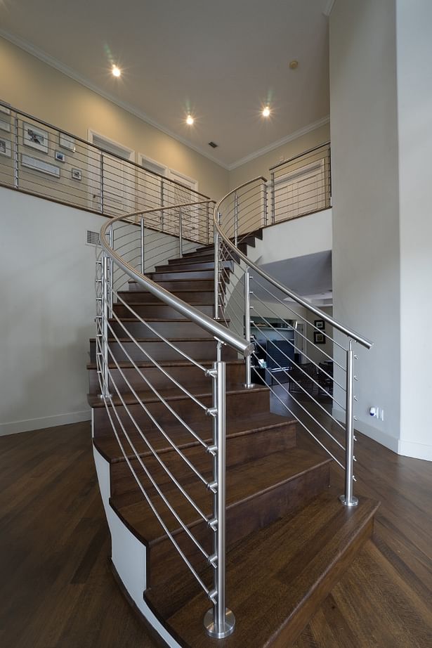 Curved Stainless Steel Rod Railings with a Top Mounted Handrail.