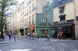 Why are the facades of many of the old residential buildings in Paris tilted backwards?