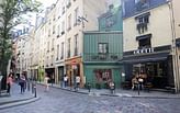 Why are the facades of many of the old residential buildings in Paris tilted backwards?