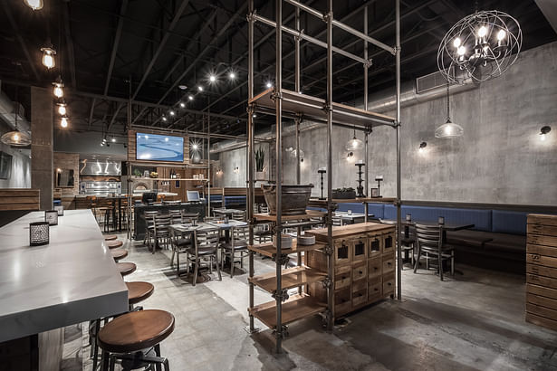 The interiors of the space were inspired by the scaffolding seen throughout the ever-evolving New York City streets. This industrial element made usually of wooden planks and metal poles has been repurposed into the space in a functional, yet aesthetic way