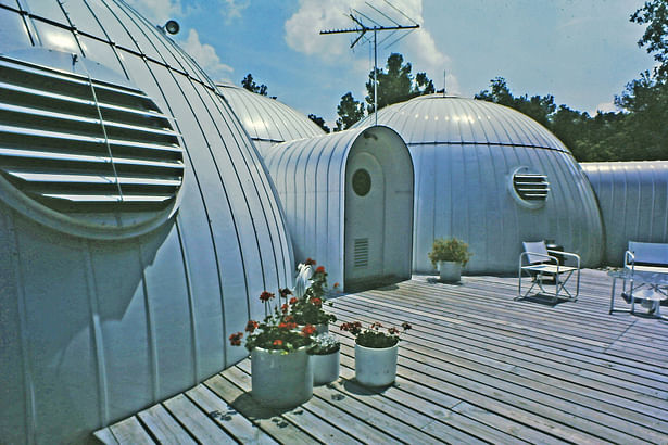four twenty six foot domes merged together like soap bubbles form the exterior shell of the 1700 square foot house.