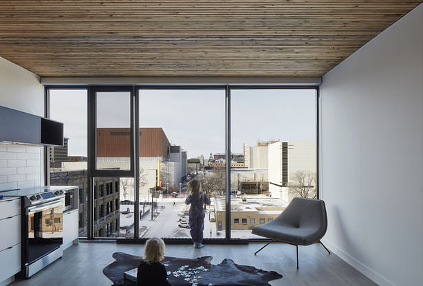 Suites with Nail-Laminated Timber structure and floor-to-ceiling views.