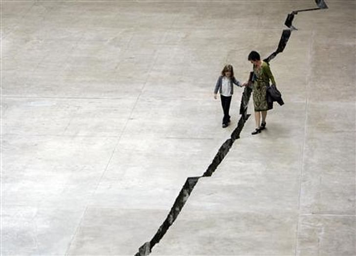 Doris Salcedo's 'Shibboleth' was specially made for the Turbine Hall of the Tate Modern and consisted of a large crack carved into the floor of the room. Credit: Luke MacGregor / Reuters