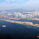 Aerial view of Kowloon East, former Kai Tak airport (foreground and left), Kowloon Bay (centre) and Kwun Tong district (right).