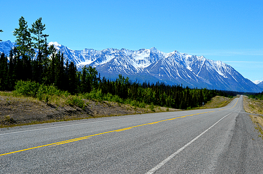 The Alaska Highway across the Yukon. Photo via wheretherobertmeetstheroad.com