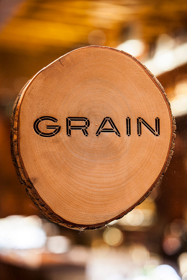 Outlet Logo branded into a timber trunk slice. Graphics by Frost*Collective, Sydney.