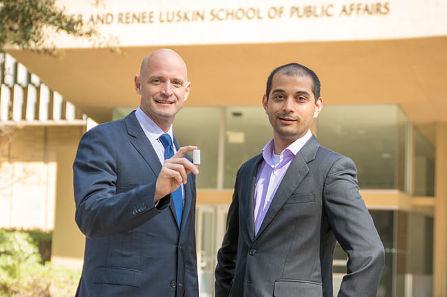 UCLA researchers J.R. DeShazo, left, and Gaurav Sant, with the CO2 infused building material. Photo by Roberto Gudino, via luskin.ucla.edu.