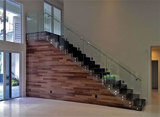 Glass panel railings feature polished stainless steel elements