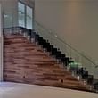 Glass panel railings feature polished stainless steel elements