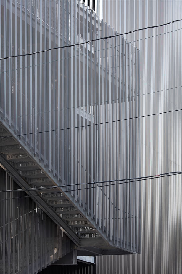 Cantilevered open-air stairs clad with a fine grain metal mesh offer unexpected views of the surroundings.