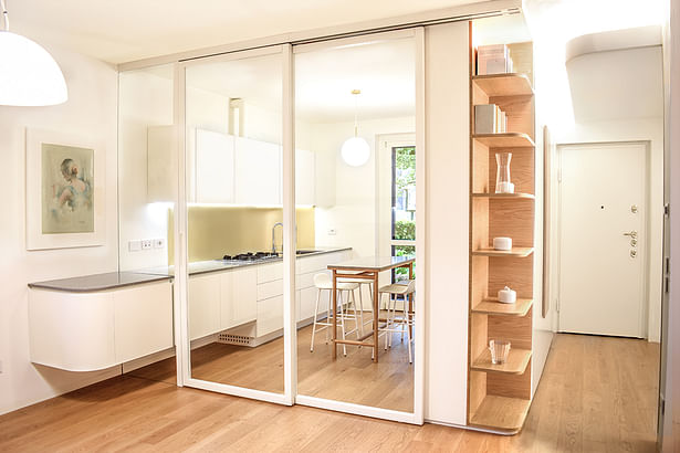kitchen separated by glass door - the entrance and the kitchen have in common one single furniture, which is openable from both sides 