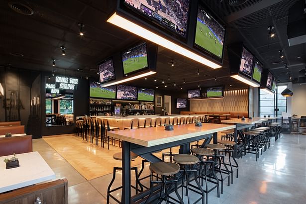 The Cage Match Ceiling references chain-link cages used in Mix Martial Arts arenas, the ceiling hides the mechanical system while integrating the televisions and lighting into a singular element that provides patrons with unobstructed views.