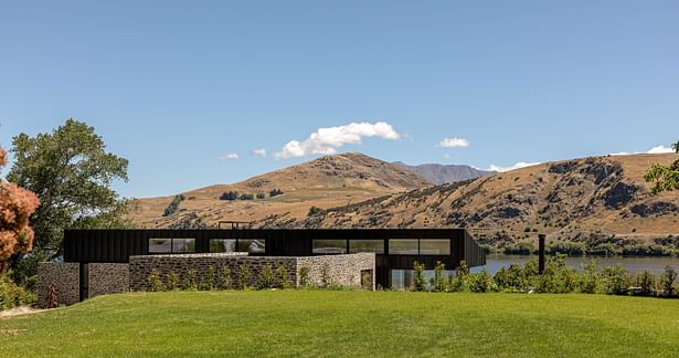 Lake Hayes Home, Queenstown, by Ben Hudson Architects - stone wall provides protection and privacy from street