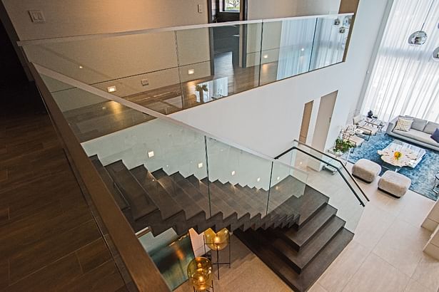 View from the second floor railing. Glass railings open and allow natural light to brighten any space.