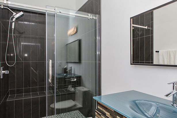 Black tile and a blue glass sink give the Guest Bath its own touches of elegance.