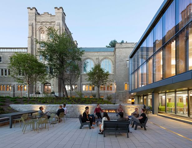 The two-story addition, scaled to the century-old building, creates an accessible and inviting front door and connects the school to a renewed campus green. The terrace, with an outdoor gas fireplace, extends gathering space into the open air. Image credit: Chuck Choi.