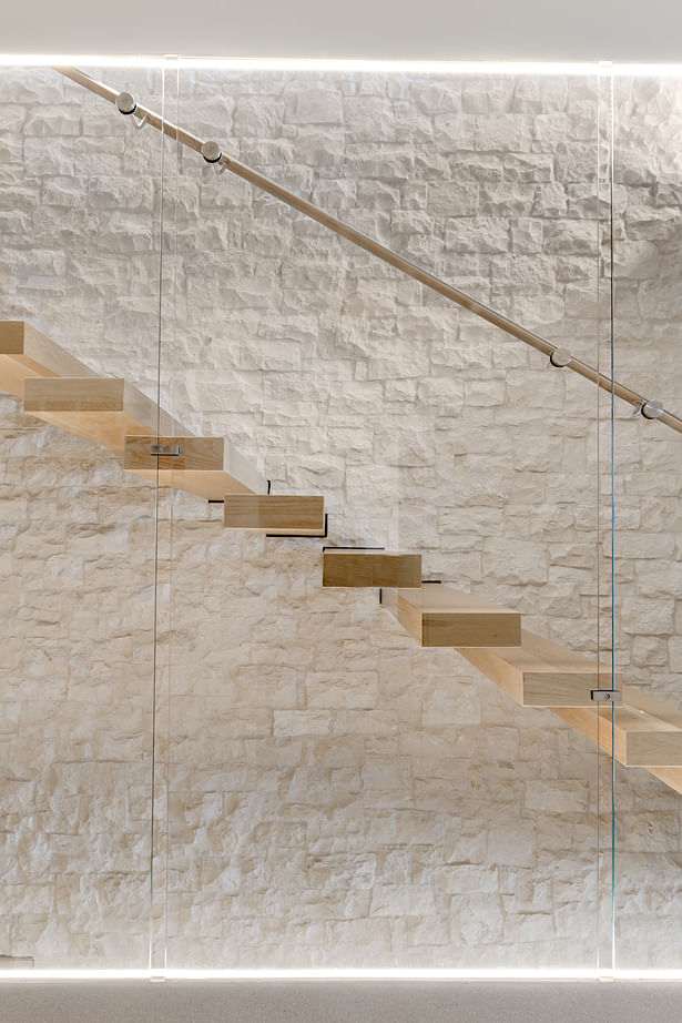 Vista House - Limestone interior wall with floating timber staircase