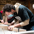 Henrique, SSA Student, using a carpentry machine to create furniture for a community space. © Critical Concrete